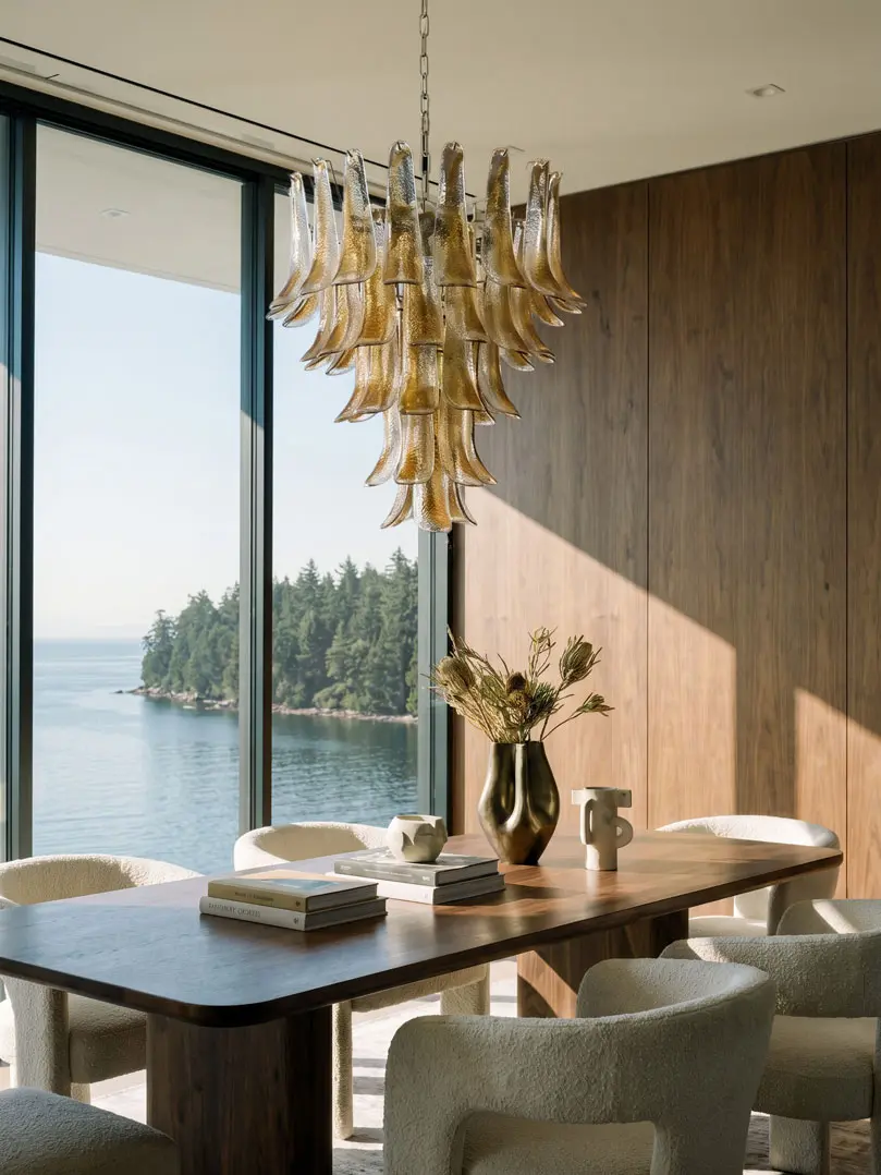 52 Murano glass amber lattimo chandelier haning in a diningroom with a seaview