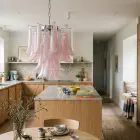 26 pink lattimo Mrano glass chandelier hangin in a kitchen