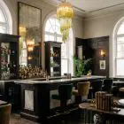 54 spiral green faded Murano prism chandelier hanging in a bar
