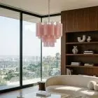 36 matte pink Murano glass tube chandelier hanging in a livingroom with a view.